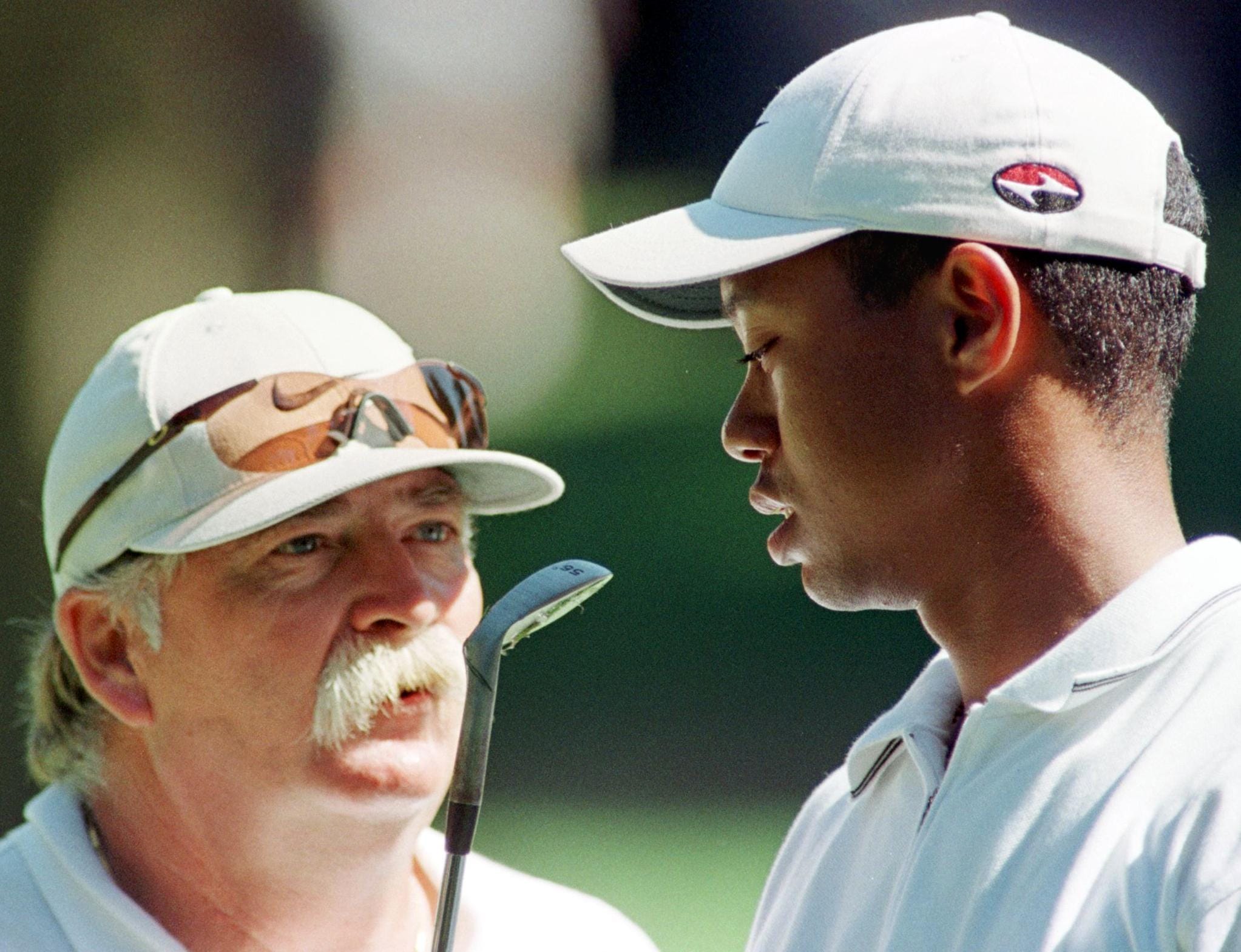 Tiger Woods (R) of the US listens to his caddie Mi - Tiger Woods